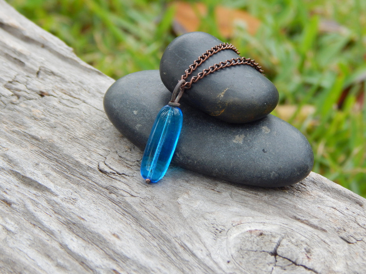 Copper wire wrapped blue glass pendant
