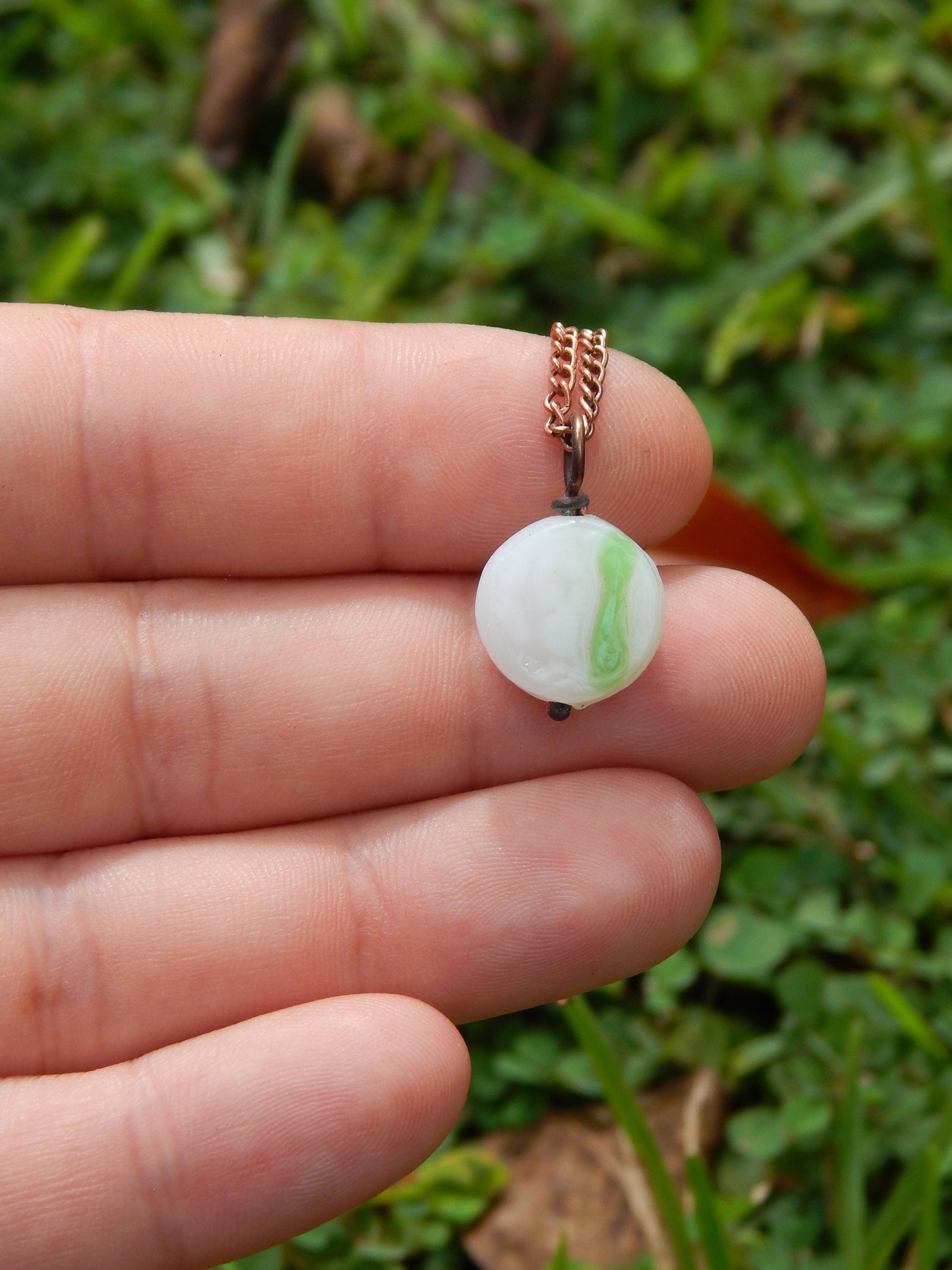 Small white and green glass pendant