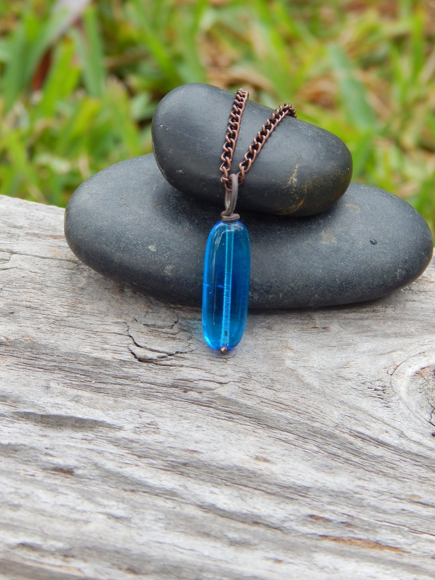 Copper wire wrapped blue glass pendant
