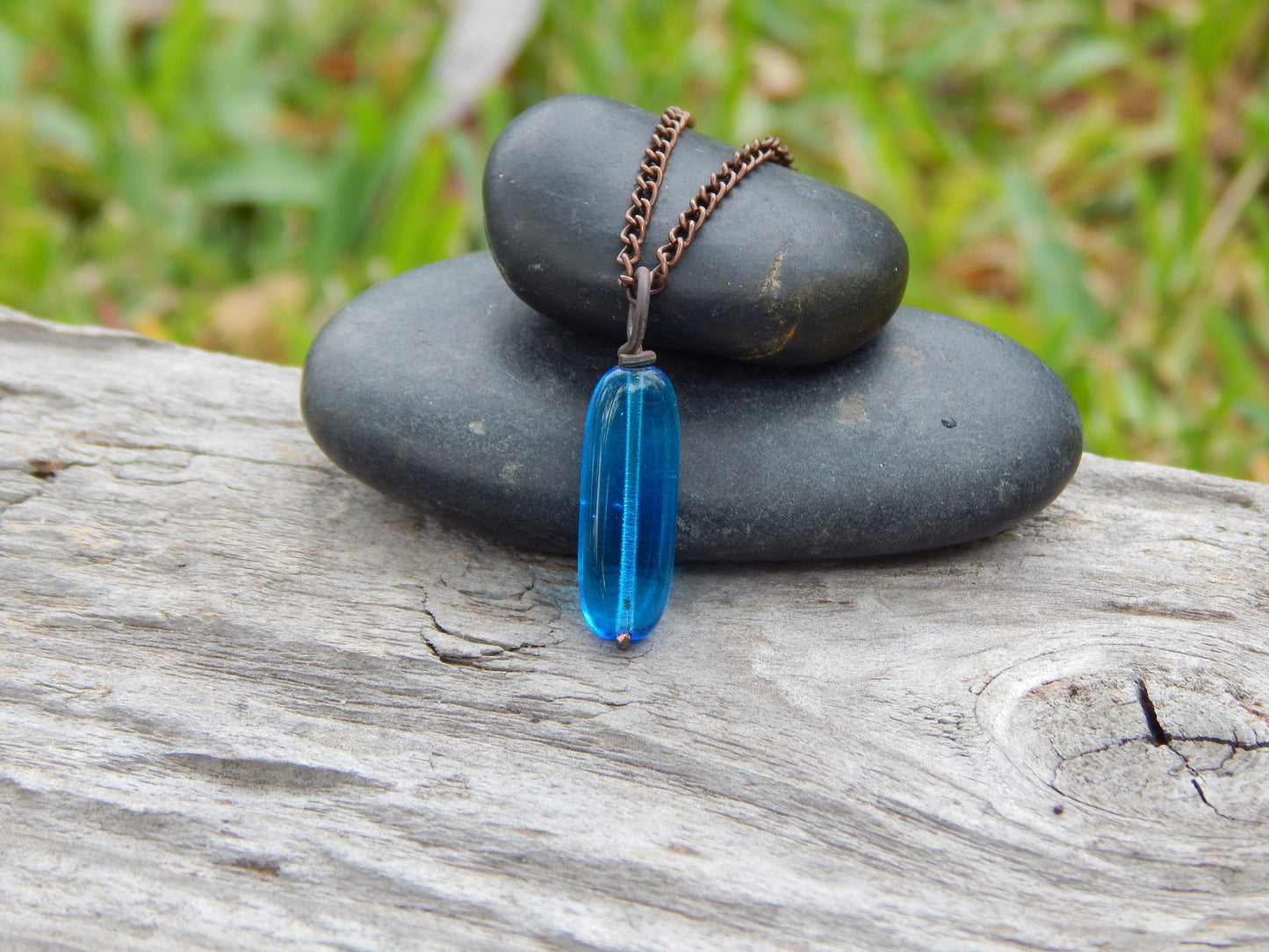 Copper wire wrapped blue glass pendant