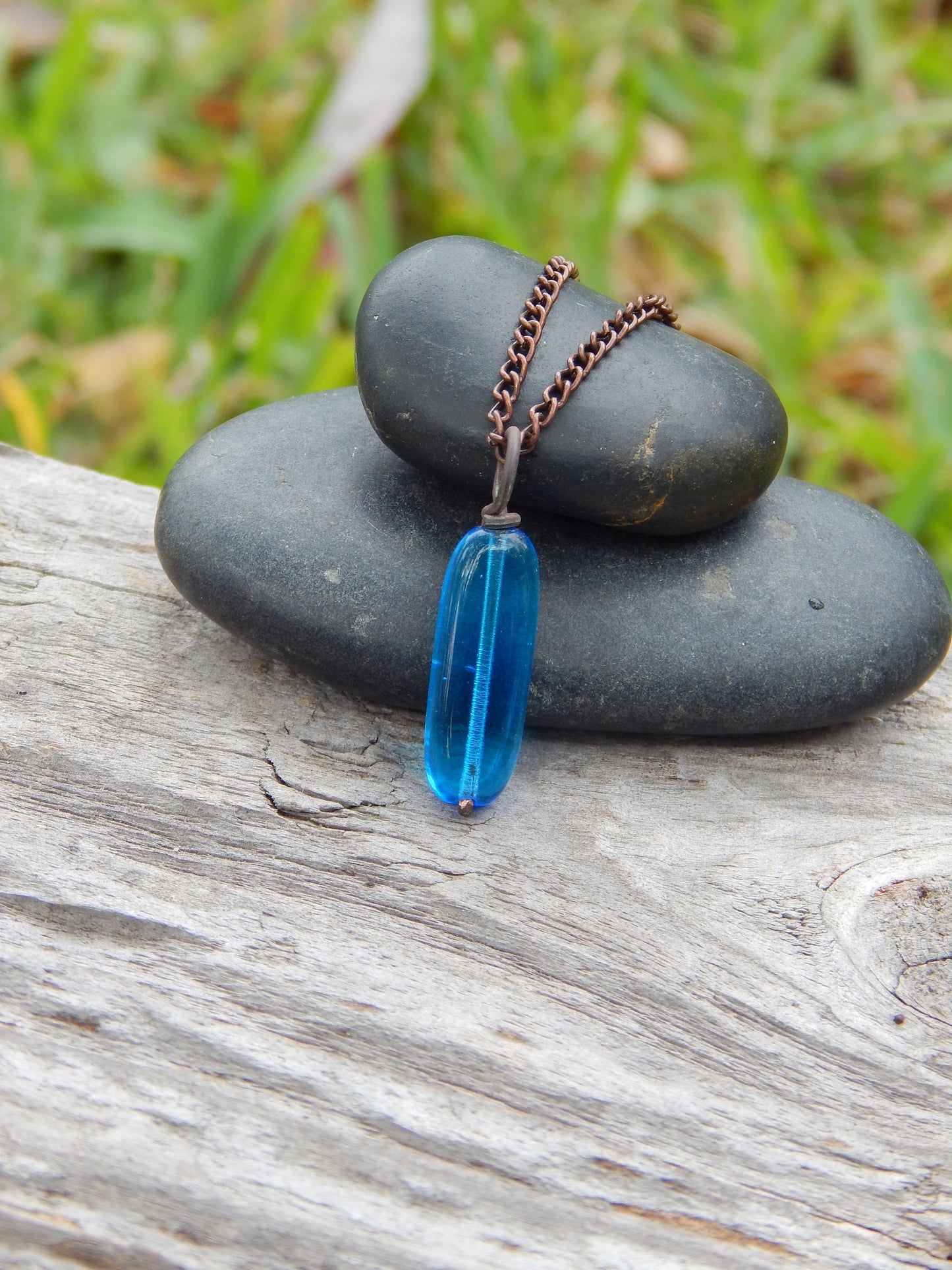 Copper wire wrapped blue glass pendant