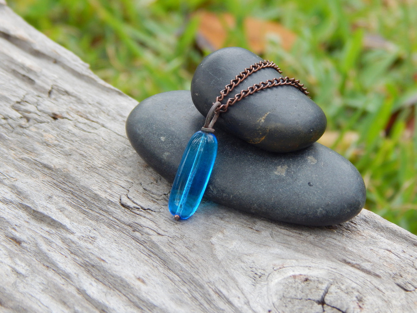 Copper wire wrapped blue glass pendant